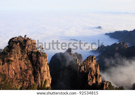 Mount Huangshan, China This is the scenic spots in Mount Huang, called the sea monkeys. The stone on top of the left peak looks like a monkey, staring at the sea of clouds.