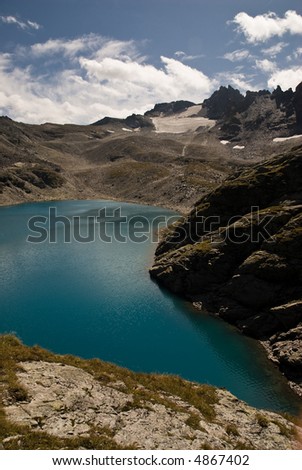Pizol mountain group with deep blue lake.