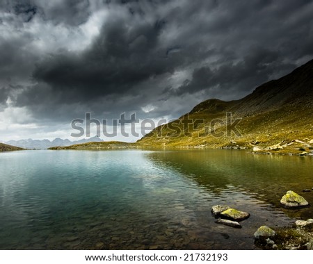 Mountain lake with storm and dark clouds, Engadin, Switzerland