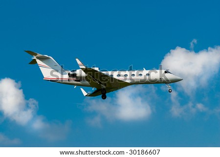 small private jet landing with gears down