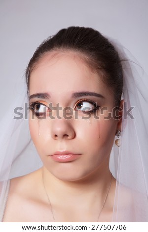 Portrait of a beautiful bride crying hurt closeup