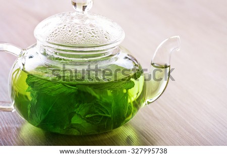 Peppermint tea in a glass pot on the table