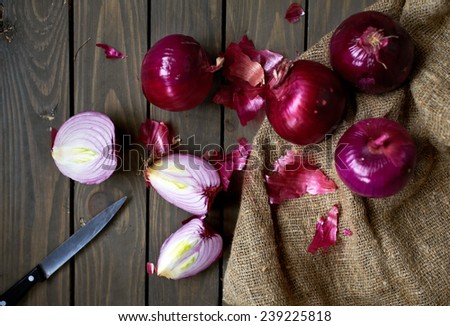 red spanish onions on rustic wooden table, selective focus