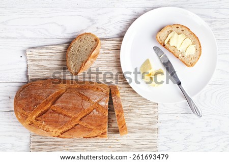 Top view of bread with butter on white table