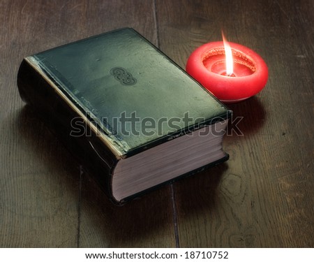 old book with candle