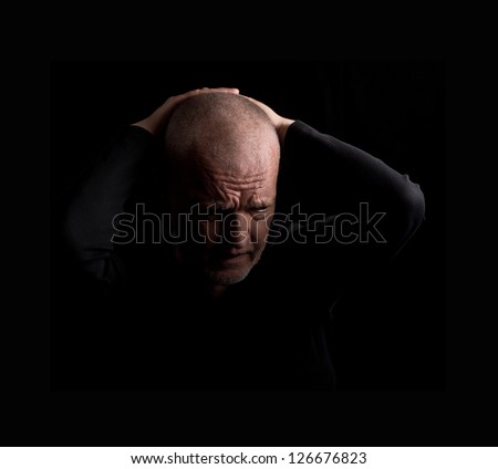 Desperate sad man on a black background