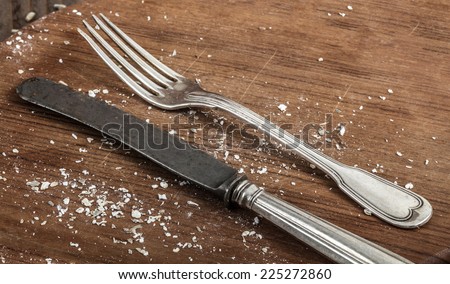 Vintage silver knife and fork  on a rustic weathered table.