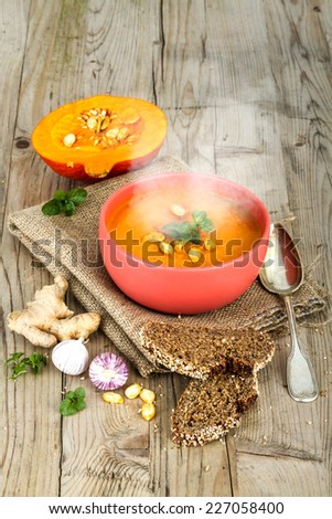 Vegetable Cream Soup in the Bowl with seeds and rustic Bread