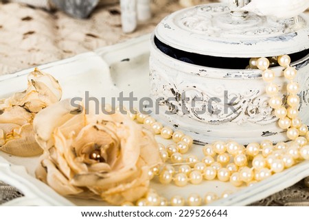antique jewelry box with pearls on ladies dressing table with shabby schic pearl necklace and lace