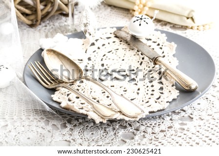 Beautifully set table in white shabby chic for Christmas Eve