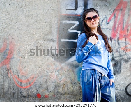 young stylish girl on a background of graffiti