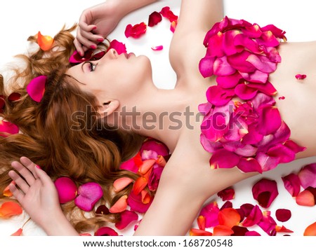Female waxing armpit in a beauty salon. Ideal smooth clear skin. Beautiful woman lying in rose petals. Depilation. Epilation