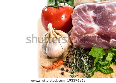 Food. Raw Meat for barbecue with fresh Vegetables and Mushrooms on wooden surface. Meat Raw Steak and spices for cooking meat.