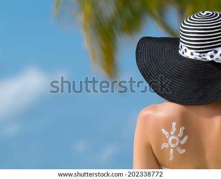 Woman with sun-shaped sun cream