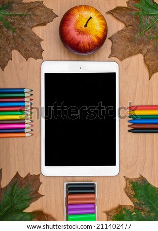 Back to School concept .  School supplies and tablet on wooden school desk from above