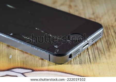 MOSCOW, RUSSIA - OCTOBER 6, 2014: Photo of a broken iPhone 5. iPhone 5 is a smartphone developed by Apple Inc. It is part of the iPhone line. iPhone is world favorite smartphone.