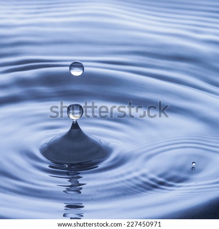 Blue water drop falling down, water splash