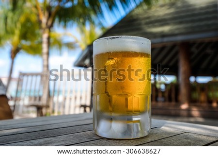 Beer glass on bar table at the open-air cafe.