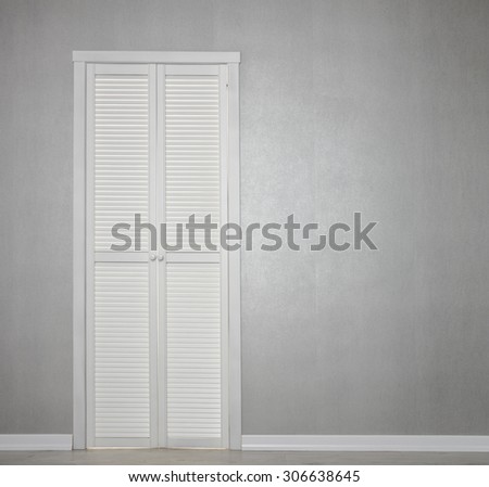 Closed White Door on grey Wall
