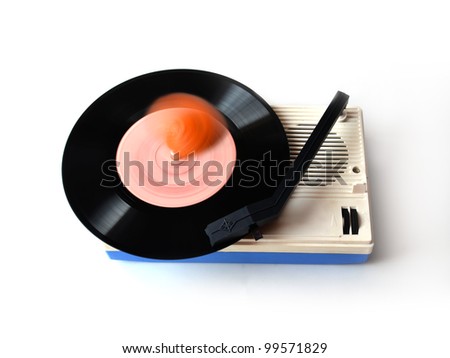 playing vinyl player with orange on a plate on a white background
