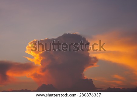 Orange mushroom cloud at sunset.