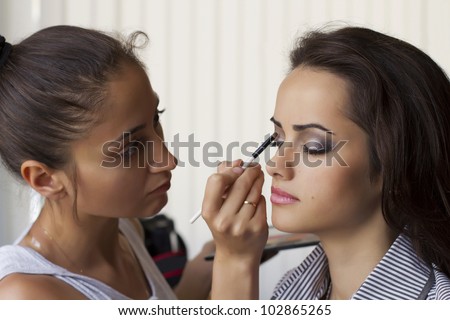 makeup artist paints a model