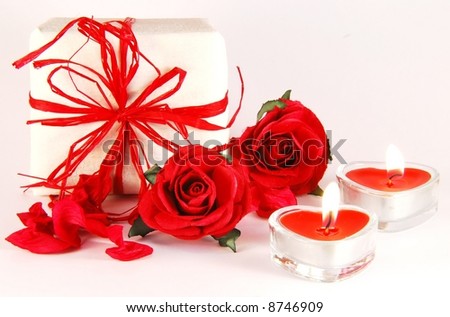 romantic still-life with red rose, box and candles