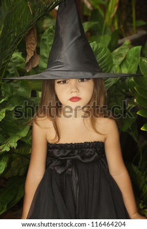 Portrait of little girl in black hat and black clothing