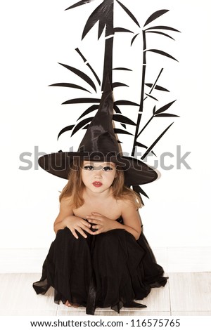 Portrait of little girl in black hat and black clothing