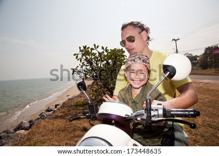 Father and daughter traveling on a motorbike