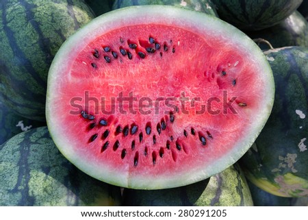 the sliced watermelons with the green fruit