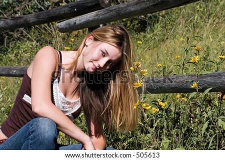 Beautiful young woman in country side, grin