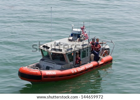 SANTA CRUZ, CA/USA - JUNE 30: Unidentified agents of the U.S. Coast Guard patrol the Santa Cruz Harbor.  The Coast Guard is part of the  U.S. Department of Homeland Security.  June 30, 2013