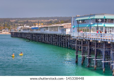 SANTA CRUZ, CA/USA - JUNE 30: The historic Santa Cruz Municipal Wharf.  Built in 1914 it extends 2,745 feet making it is the longest pier on the West Coast of the United States. June 30, 2013