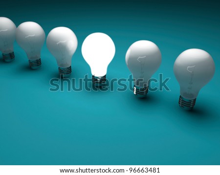One lit light bulb amongst other broken light bulbs