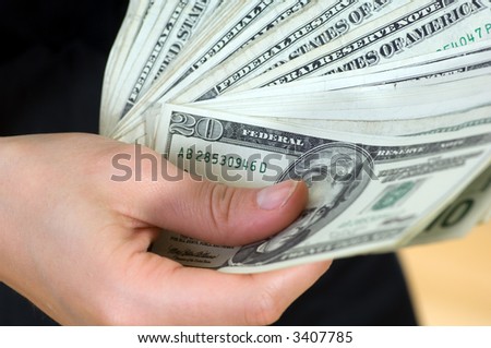 a lot of Dollar bank note on the hand
