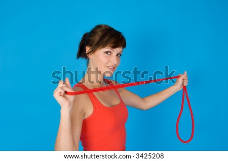a Girl with skipping rope in front of a blue background