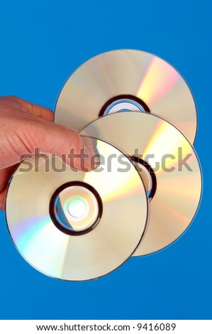 a close up view of a hand with data carrier cd, dvd