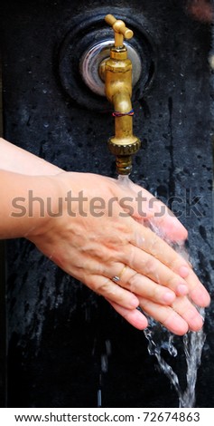 close-ups of hand washing with tap water under