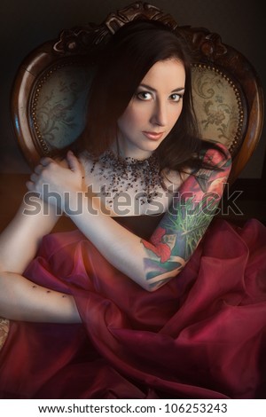 Beautiful girl with stylish make-up and tattooed arm. tattoo