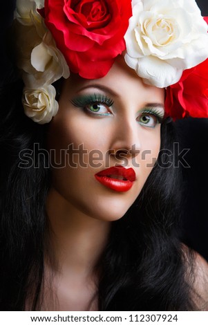 portrait of pretty young girl with roses. red roses