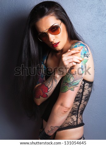 Young beautiful sexy brunette with gorgeous tattoo on her arms. tattoo.