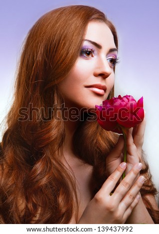 Beautiful c woman with fresh health skin of face and red flower. flower