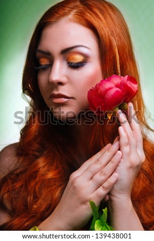 Beautiful c woman with fresh health skin of face and red flower. flower