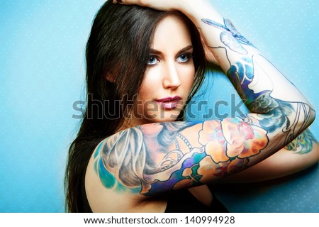 Beautiful Girl With Stylish Make-Up And Tattooed Arms. Tattoo