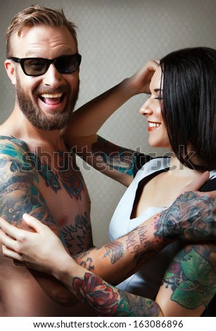 tattooed couple hugging each other.tattoo