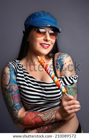 Beautiful girl with stylish make-up and tattooed arms. tattoo