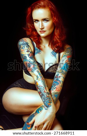 Beautiful girl with stylish make-up and tattooed arms. tattoo