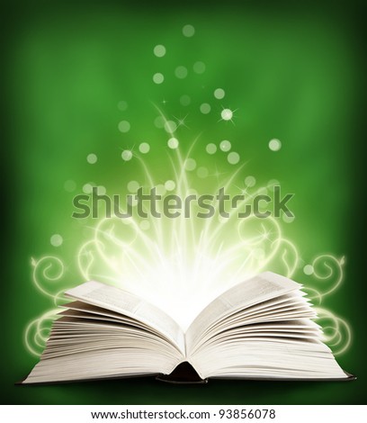 The  open Magic Book with sparklings on an green background