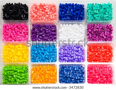 Colorful toy beads in a plastic box.